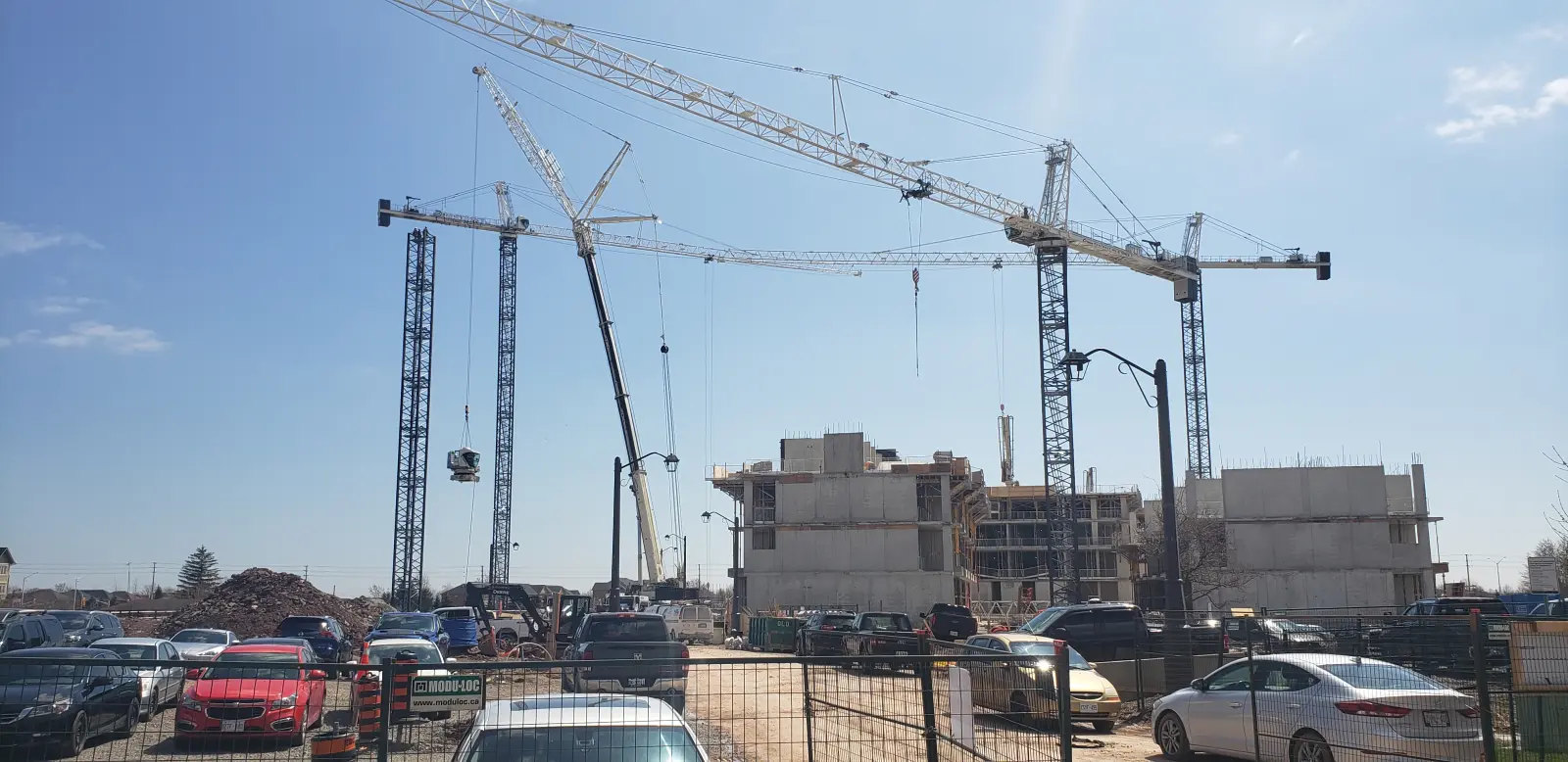 Rough terrain crane at a commercial construction site erecting steel