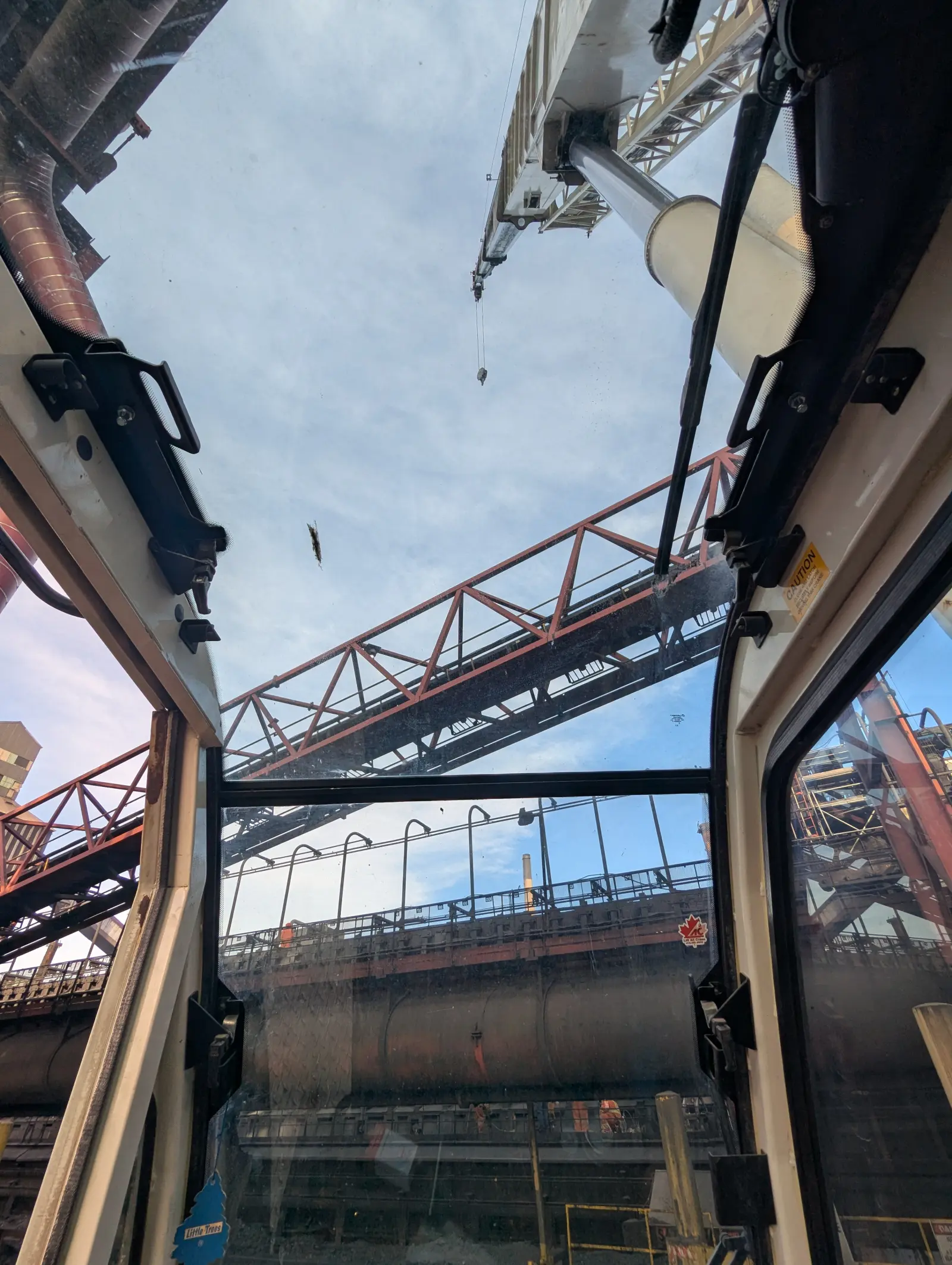 View from crane cab looking up at yellow hydraulic boom